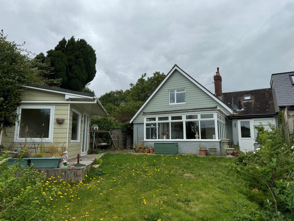 Lot: 179 - FREEHOLD HOUSE FOR IMPROVEMENT ON SOUGHT AFTER PRIVATE ESTATE - A view from the back garden towards the house